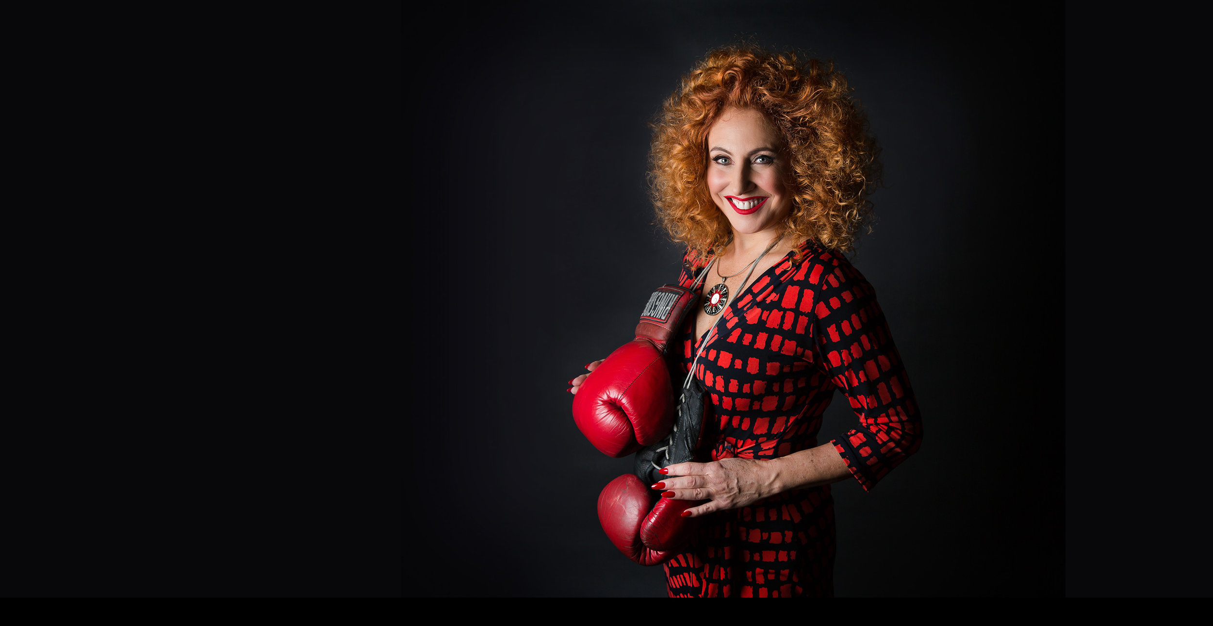 Catherine Kerr, CEO and Founder of Warrior Sales Academy, standing with boxing gloves, symbolizing her expertise and leadership in sales training.